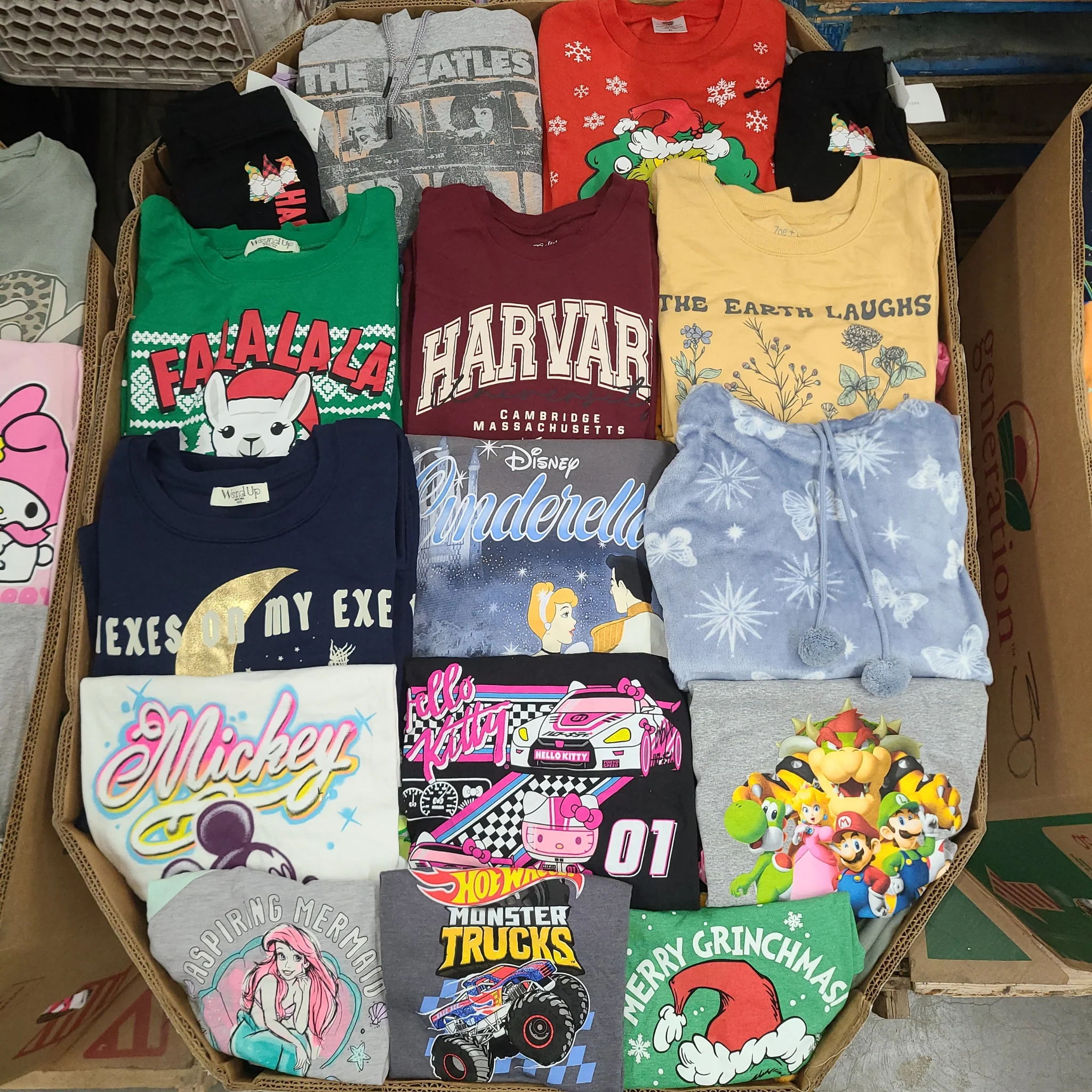 Licensed Graphic Tees Wholesale Lot with 700 brand-new licensed graphic T-shirts and sweatshirts in mixed kids' and adult sizes.