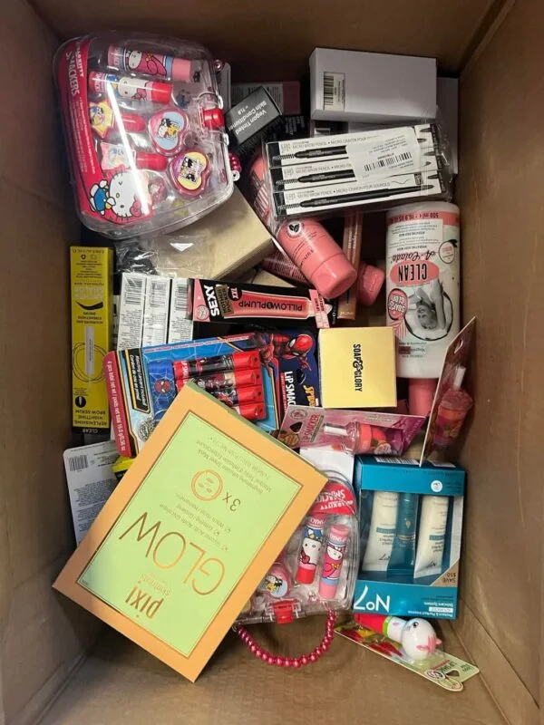 Makeup Mystery Box Pallets with 5 wholesale beauty mystery boxes containing assorted cosmetics, skincare products, makeup brushes, and beauty accessories