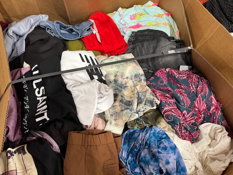 Luxury Retailer Apparel Pallets with approximately 350–400 premium clothing pieces ready for wholesale resale, including designer apparel, jackets, dresses, jeans, tops, and fashion accessories.