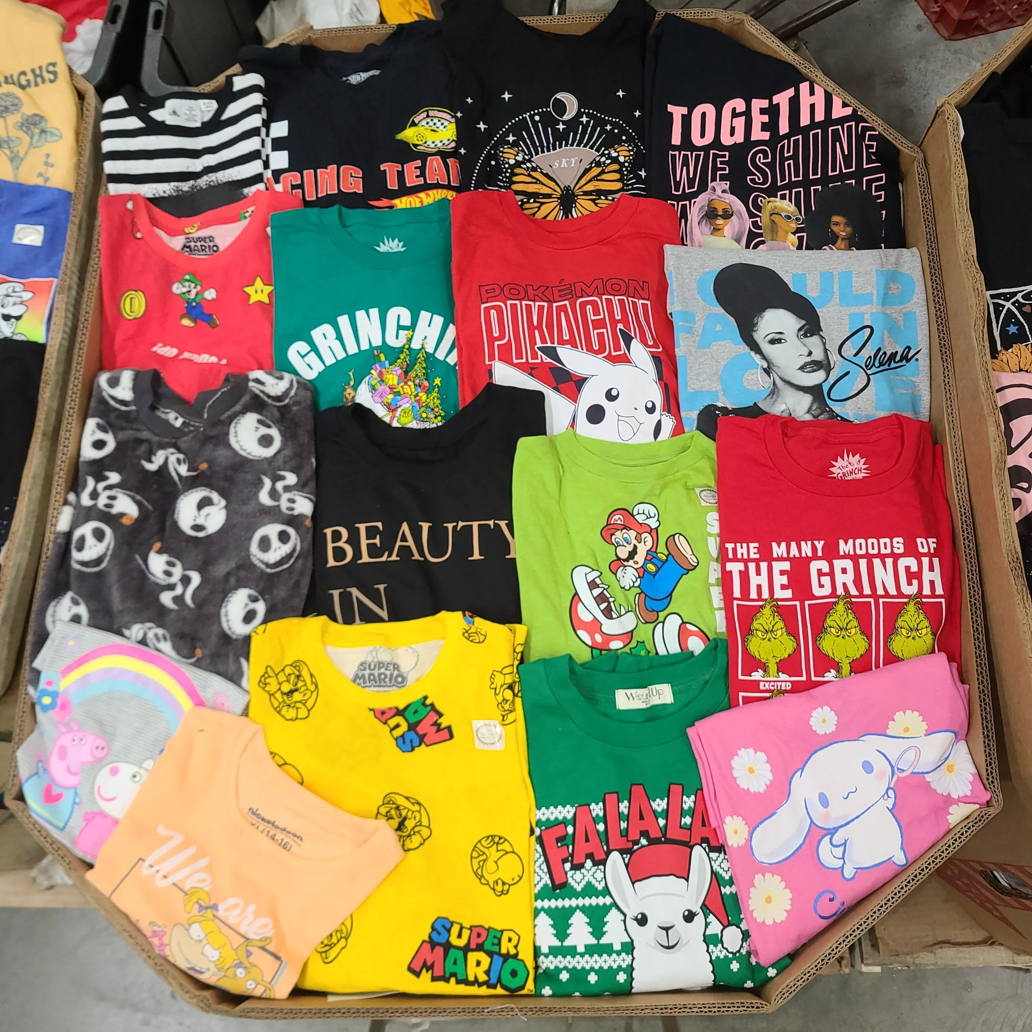 Licensed Graphic Tees Wholesale Lot with 700 brand-new licensed graphic T-shirts and sweatshirts in mixed kids' and adult sizes.