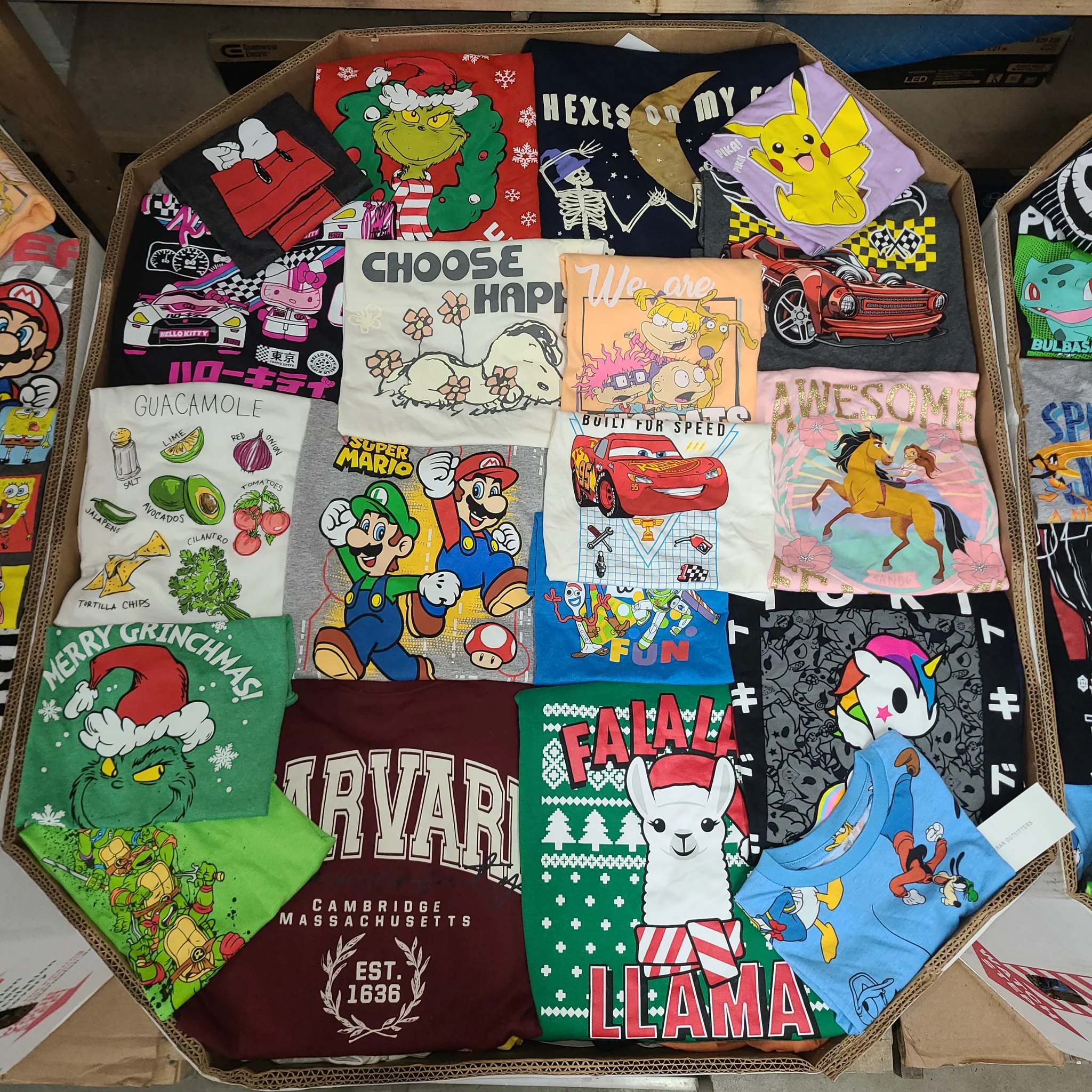 Licensed Graphic Tees Wholesale Lot with 700 brand-new licensed graphic T-shirts and sweatshirts in mixed kids' and adult sizes.