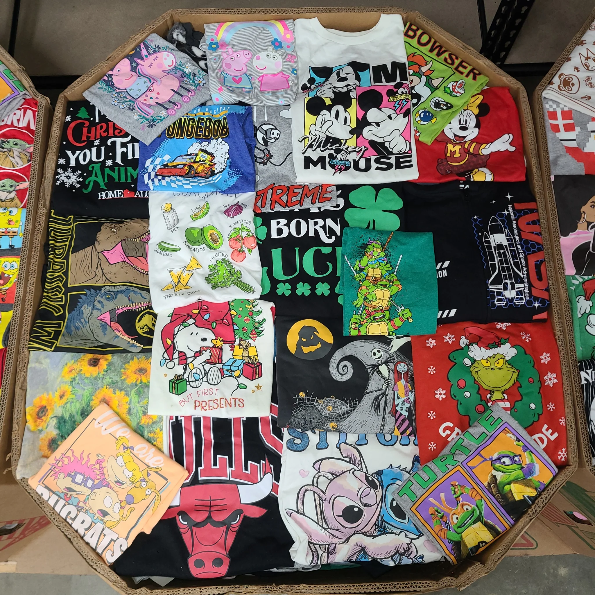 Licensed Graphic Tees Wholesale Lot with 700 brand-new licensed graphic T-shirts and sweatshirts in mixed kids' and adult sizes.