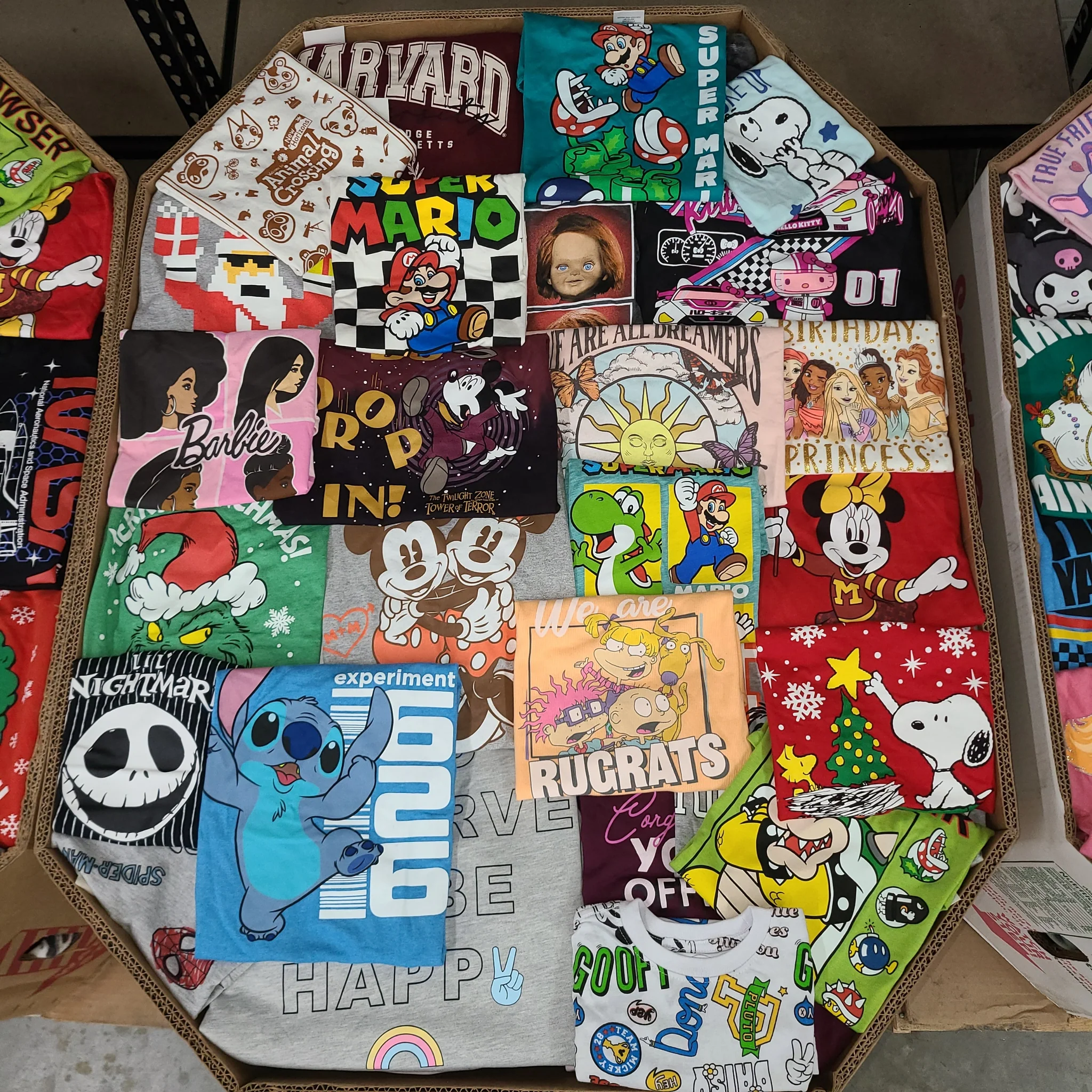 Licensed Graphic Tees Wholesale Lot with 700 brand-new licensed graphic T-shirts and sweatshirts in mixed kids' and adult sizes.