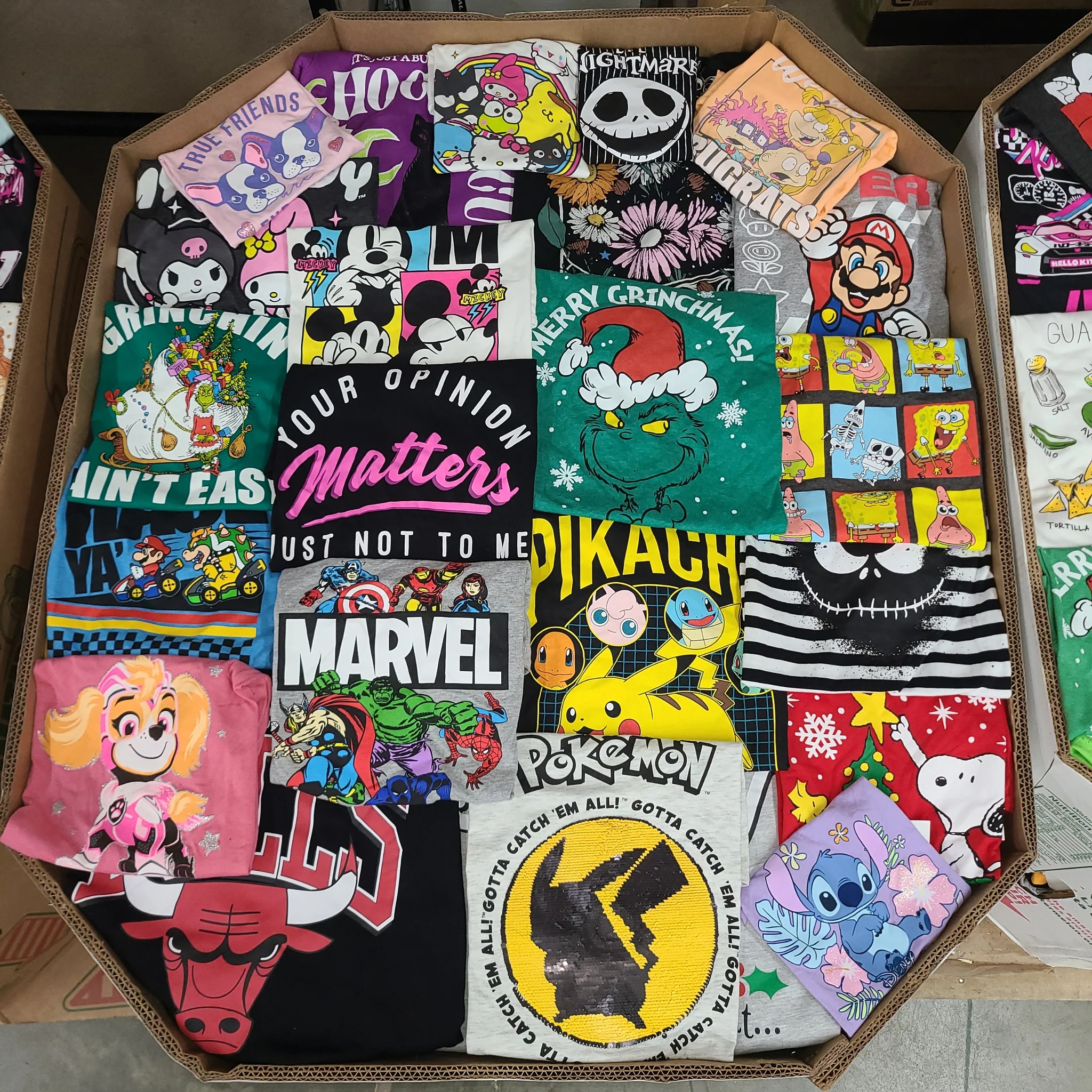 Licensed Graphic Tees Wholesale Lot with 700 brand-new licensed graphic T-shirts and sweatshirts in mixed kids' and adult sizes.