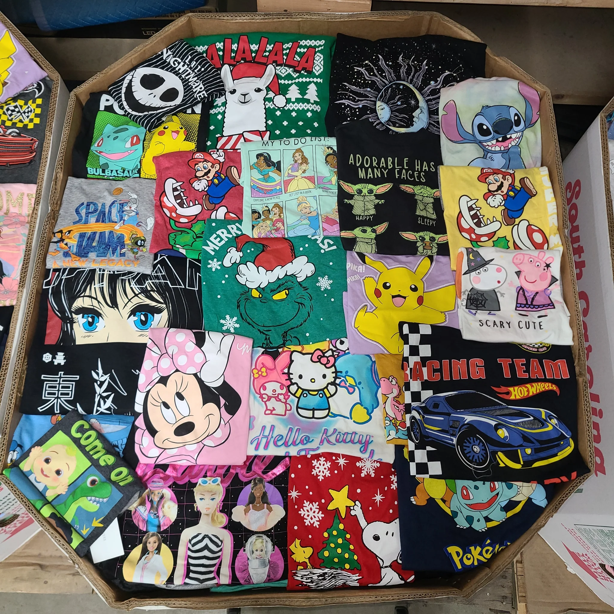 Licensed Graphic Tees Wholesale Lot with 700 brand-new licensed graphic T-shirts and sweatshirts in mixed kids' and adult sizes.