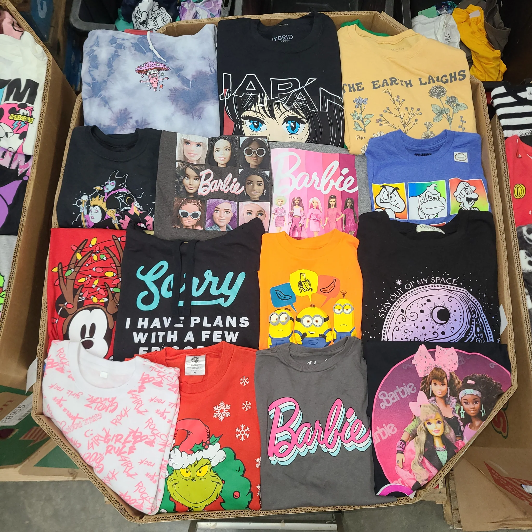 Licensed Graphic Tees Wholesale Lot with 700 brand-new licensed graphic T-shirts and sweatshirts in mixed kids' and adult sizes.